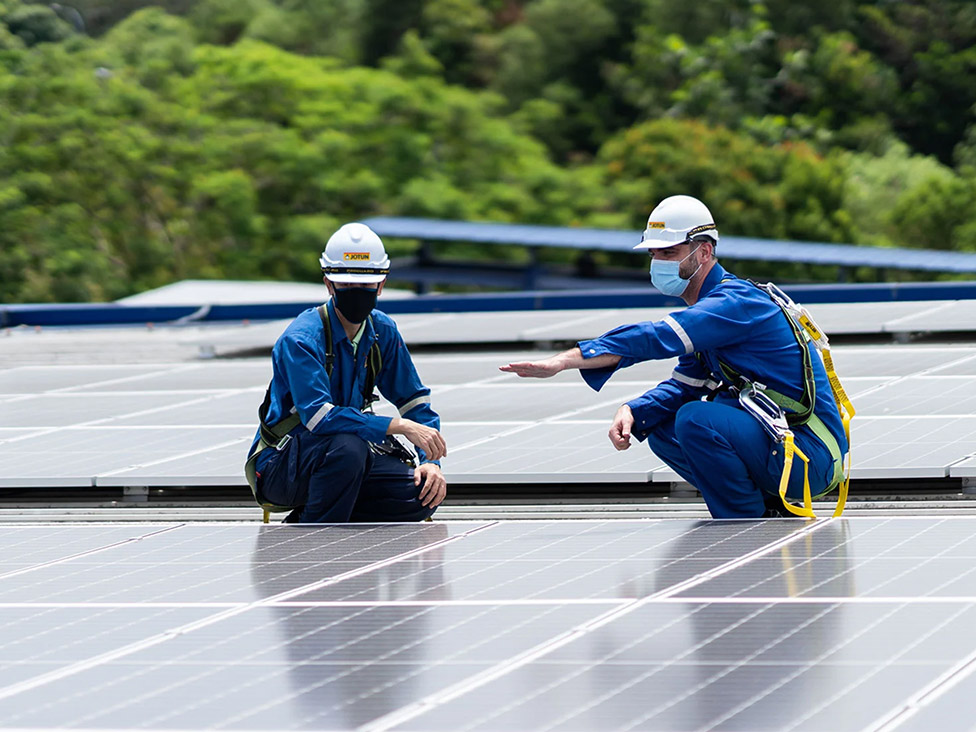 Workers onto of solar panel