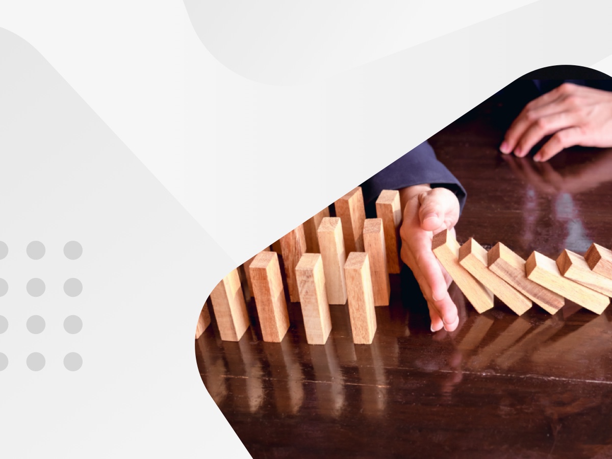 A person playing dominoes with wooden blocks.