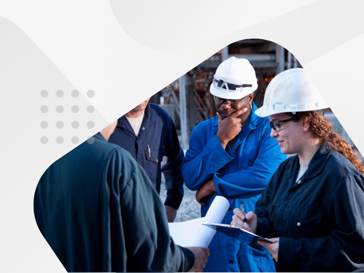 Several individuals wearing hard hats engaged in conversation