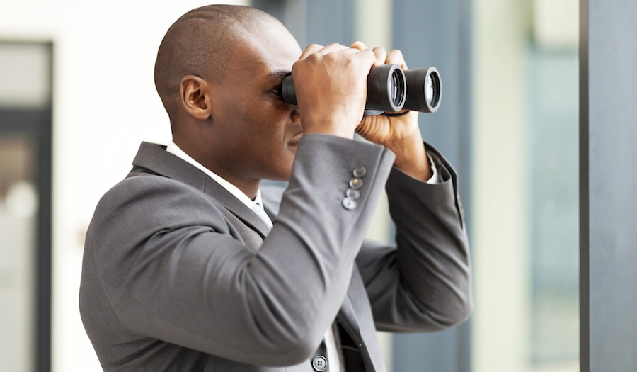 business man using binoculars