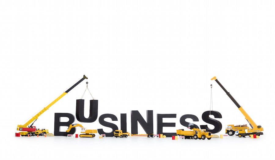 Build up a business: Machines building business-word.