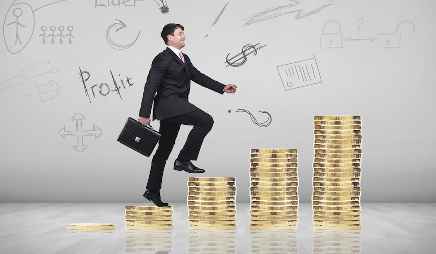 Businessman climbing gold coins stacks on the gray background