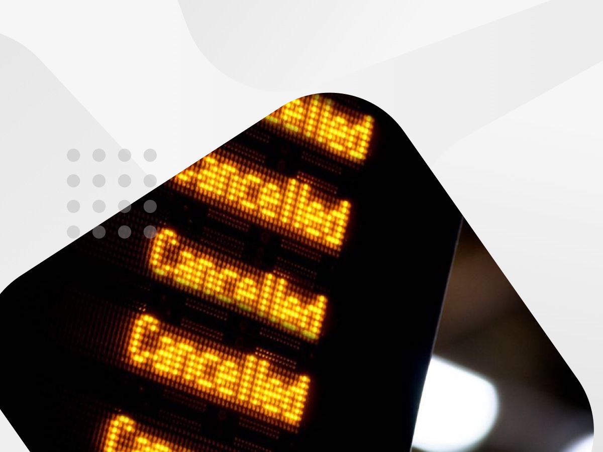 Flight information board displaying the word "cancelled" in bold letters.
