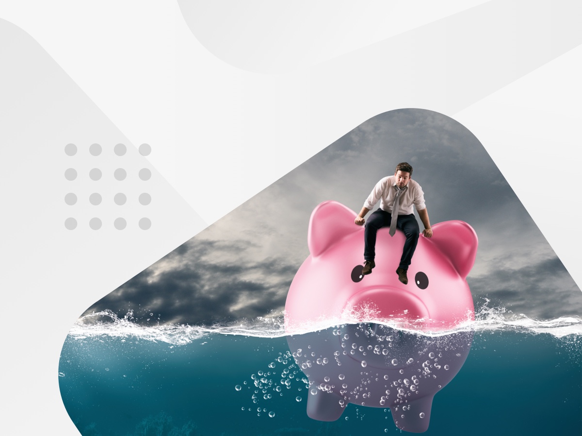 A man sitting on a pink piggy bank, symbolising financial stability and savings.